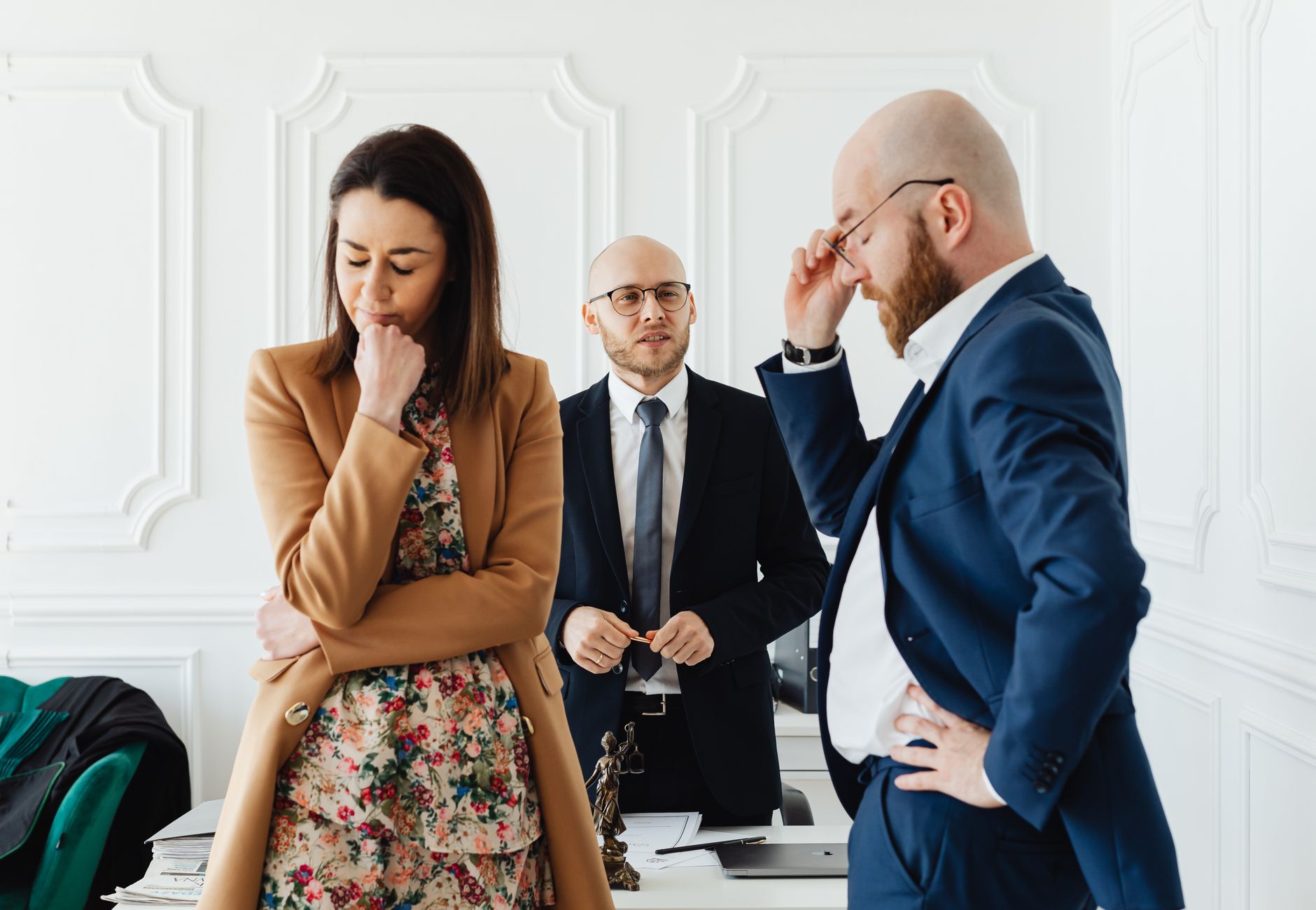 Business scenario with a couple discussing with a lawyer in a formal office.