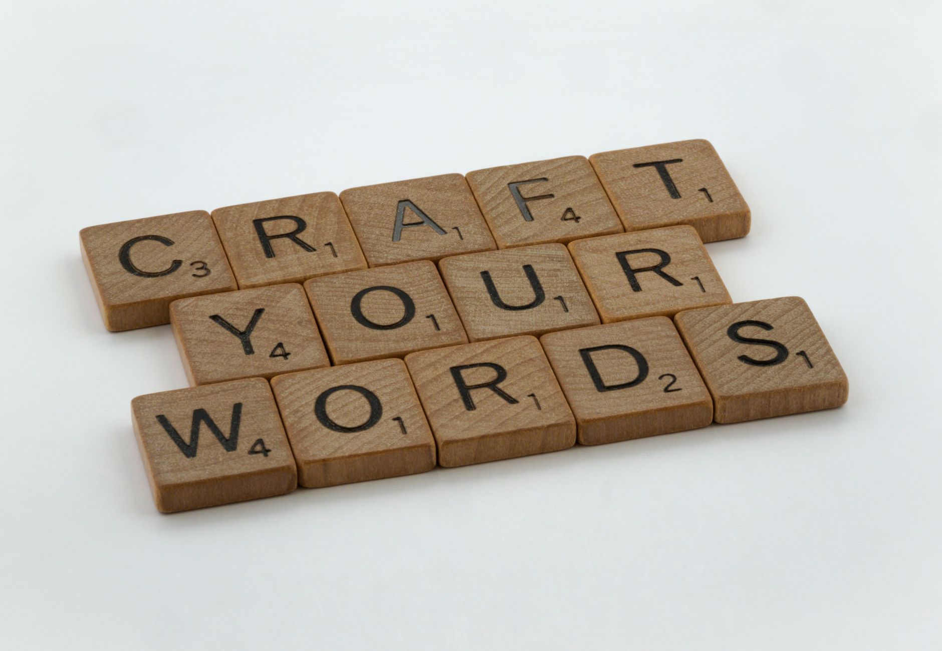 Creative arrangement of word tiles spelling 'Craft Your Words' on a white background.
